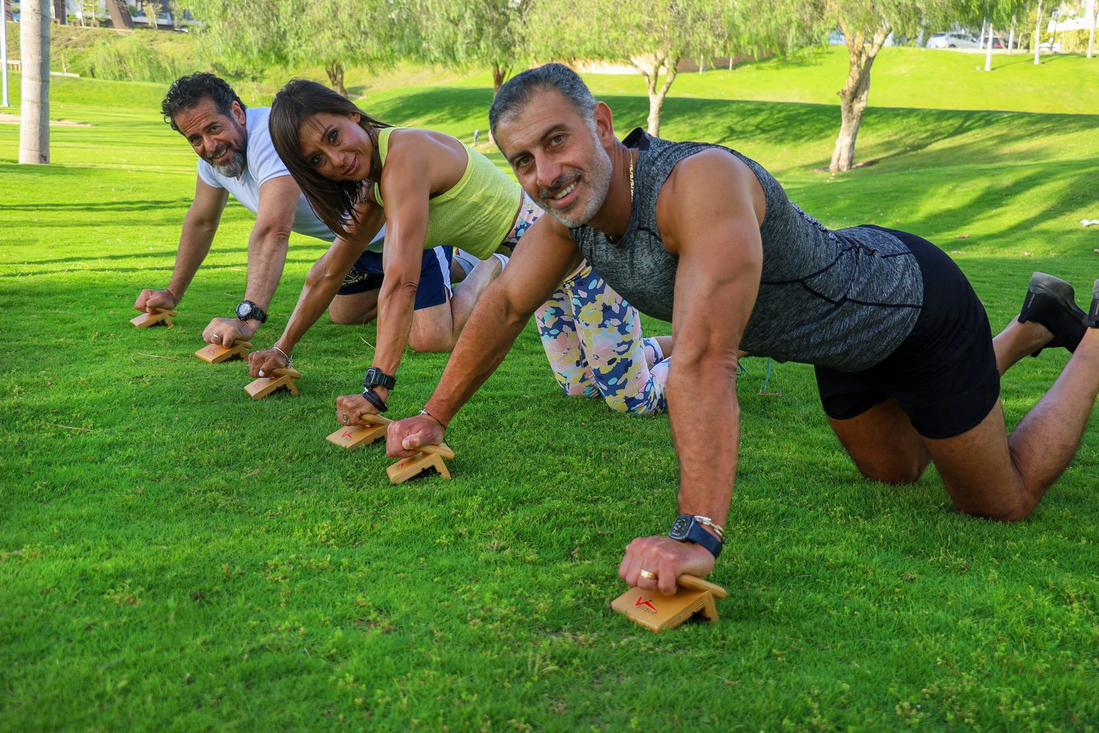Group performing elevated push-up variations on sturdy exercise surfaces